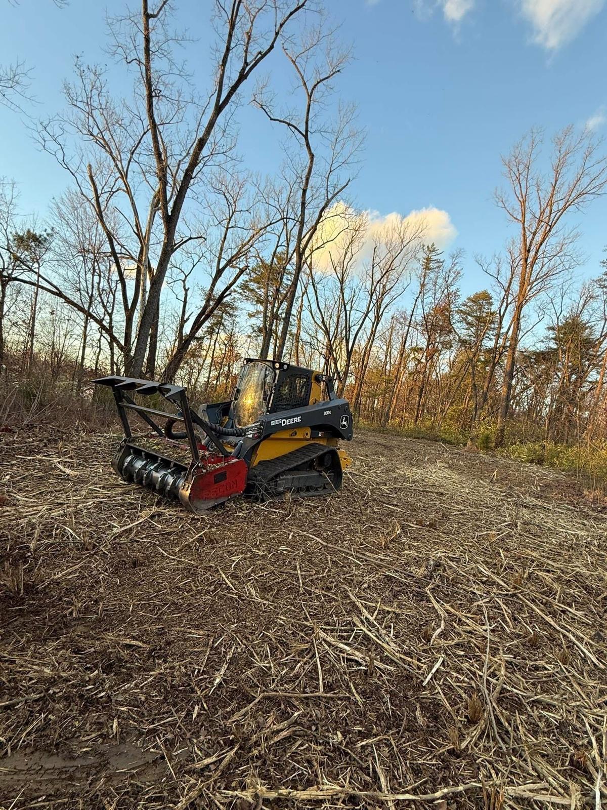 Forestry mulcher on a cleared wooded hillside